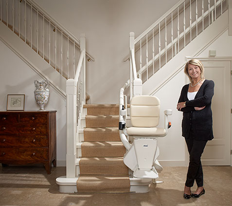 Woman stood next to stairlift